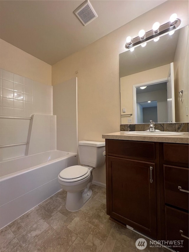 bathroom with visible vents, bathing tub / shower combination, toilet, and vanity