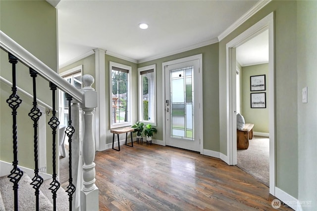 entryway featuring crown molding, baseboards, stairs, and wood finished floors