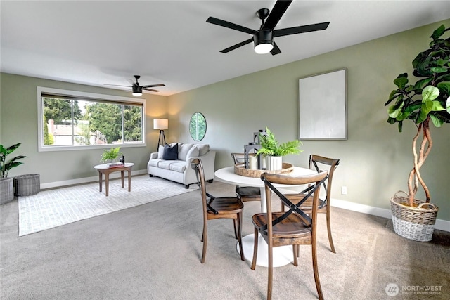 dining room featuring carpet flooring, a ceiling fan, and baseboards