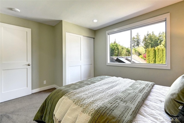 carpeted bedroom featuring baseboards, recessed lighting, and a closet