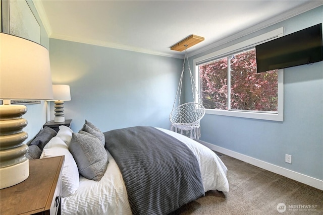 carpeted bedroom featuring crown molding and baseboards