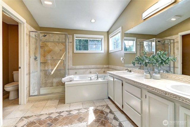 full bath with a garden tub, a sink, a stall shower, and toilet