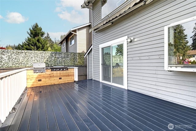 wooden deck with a grill