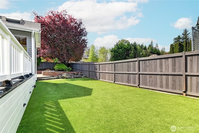 view of yard with a fenced backyard