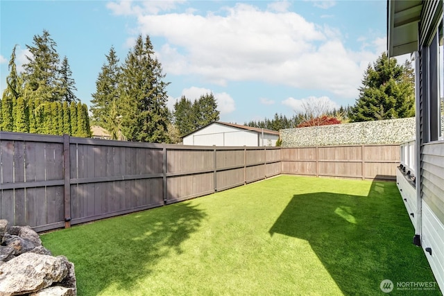 view of yard with a fenced backyard