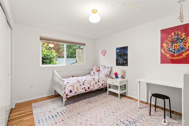 bedroom featuring baseboards and wood finished floors