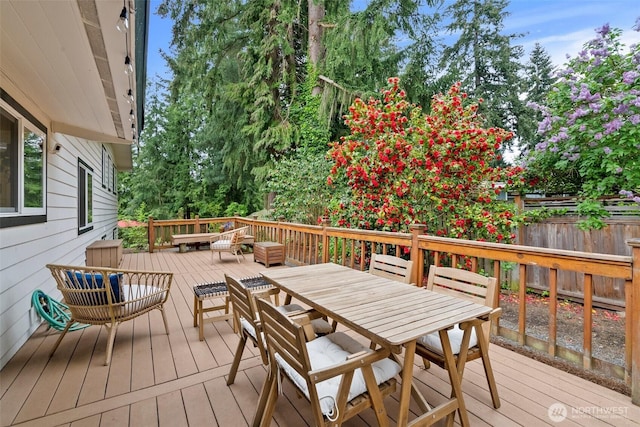 wooden terrace with fence and outdoor dining space