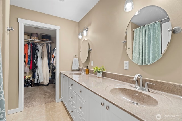 3688 E Indiana St, Port Orchard, WA 98366 - bathroom with double vanity, a walk in closet, and tile patterned floors