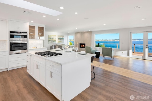 kitchen with recessed lighting, double oven, and dark wood-style floors