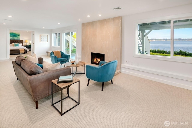living room with visible vents, recessed lighting, plenty of natural light, and light carpet