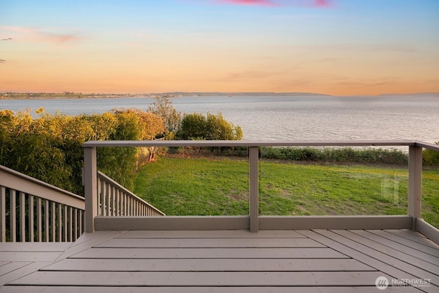 deck featuring a lawn and a water view