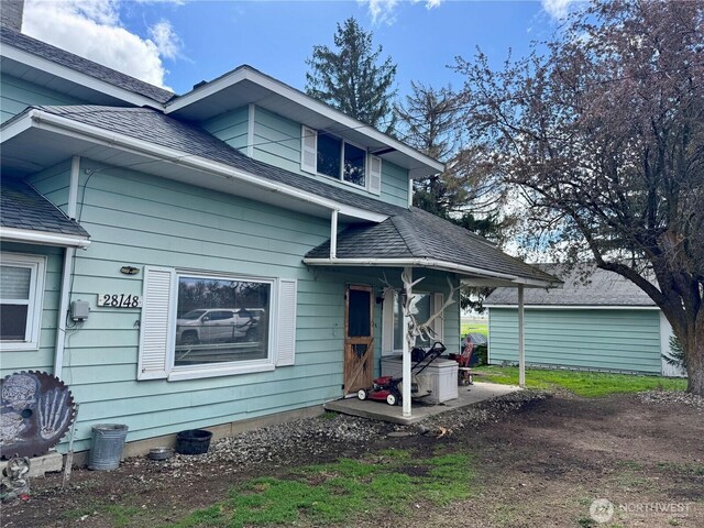 view of front of house with a shingled roof