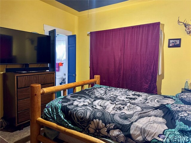 carpeted bedroom with connected bathroom