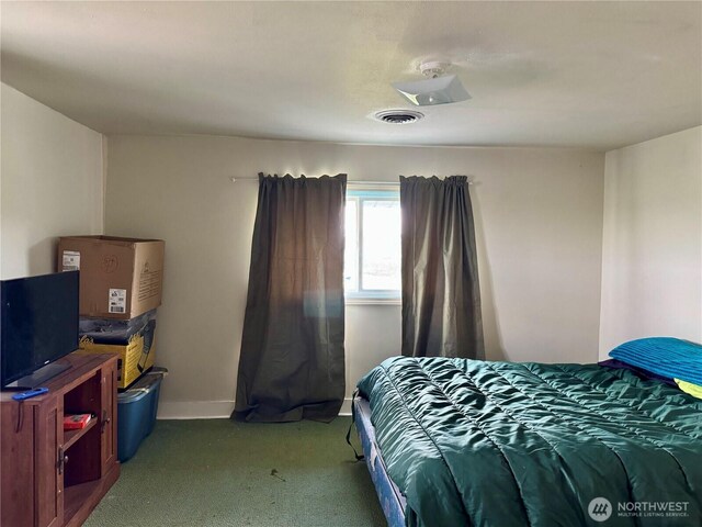 carpeted bedroom with baseboards and visible vents