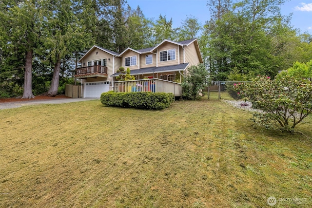 view of front of property featuring a garage, a front lawn, fence, and driveway