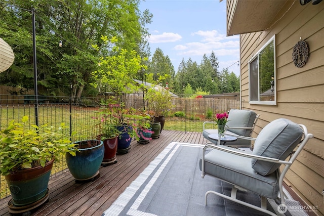 view of patio featuring a fenced backyard and a wooden deck