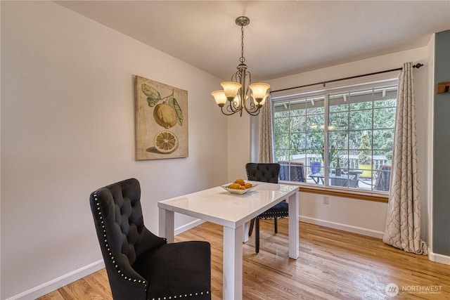34086 Bridge View Dr NE, Kingston, WA 98346 - dining area with baseboards, a chandelier, and light wood finished floors