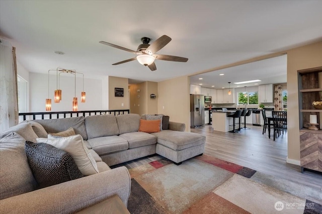 3507 222nd St SW, Mountlake Terrace, WA 98043 - living area with light wood-style floors, ceiling fan, recessed lighting, and a chandelier
