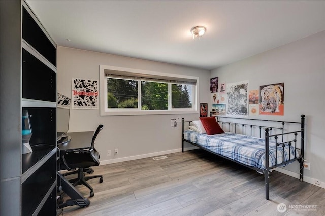 3507 222nd St SW, Mountlake Terrace, WA 98043 - bedroom with a desk, wood finished floors, and baseboards