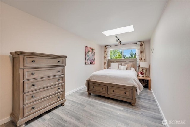 3507 222nd St SW, Mountlake Terrace, WA 98043 - bedroom with a skylight, baseboards, and light wood-style floors
