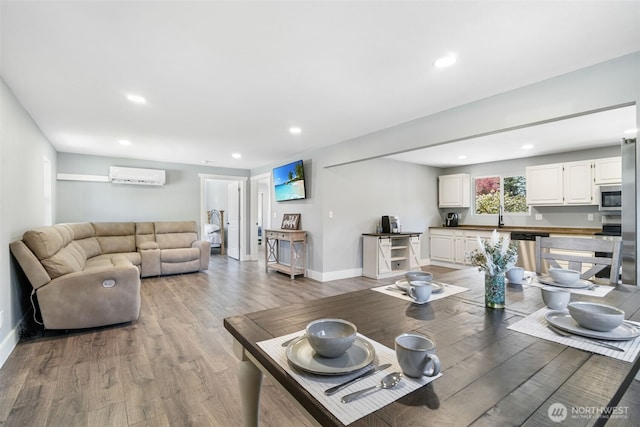 245 Stowell Rd, Salkum, WA 98570 - living area with an AC wall unit, baseboards, recessed lighting, and light wood-style floors