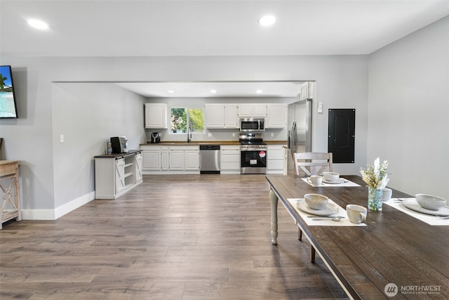 245 Stowell Rd, Salkum, WA 98570 - living room featuring dark wood-style flooring, baseboards, recessed lighting, and electric panel