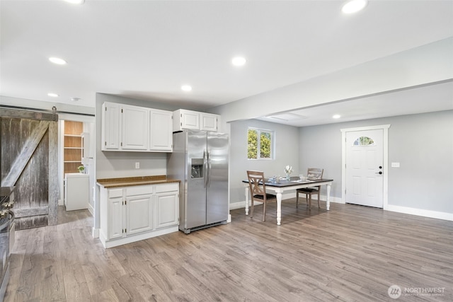 245 Stowell Rd, Salkum, WA 98570 - kitchen featuring stainless steel refrigerator with ice dispenser, a barn door, light wood-style flooring, and recessed lighting