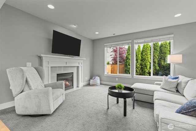 living area with baseboards, plenty of natural light, and recessed lighting
