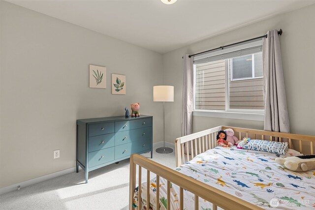 bedroom with baseboards and carpet