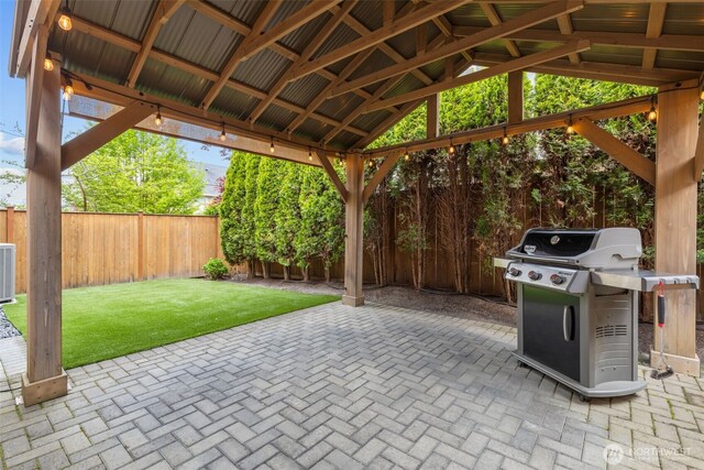 view of patio / terrace with a fenced backyard, a gazebo, and grilling area