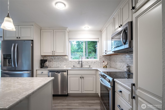 3515 W Tapps Dr E, Lake Tapps, WA 98391 - kitchen with wood finished floors, light countertops, tasteful backsplash, a sink, and stainless steel appliances