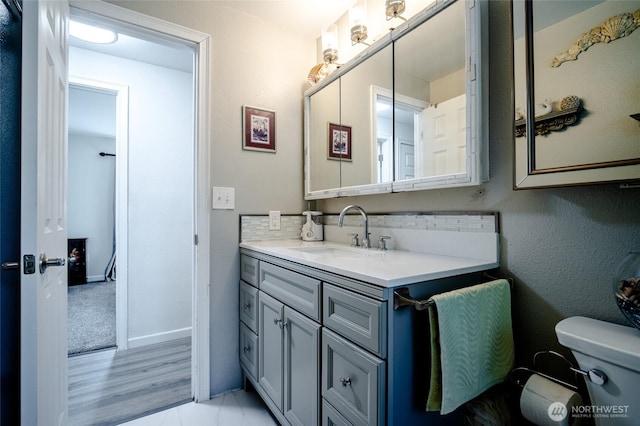 3515 W Tapps Dr E, Lake Tapps, WA 98391 - bathroom featuring toilet, baseboards, and vanity