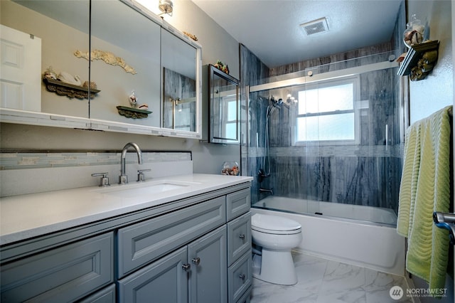 3515 W Tapps Dr E, Lake Tapps, WA 98391 - bathroom featuring visible vents, vanity, combined bath / shower with glass door, toilet, and marble finish floor