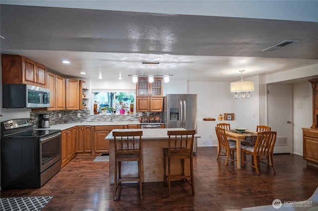 3515 W Tapps Dr E, Lake Tapps, WA 98391 - kitchen featuring backsplash, stainless steel appliances, visible vents, and dark wood-type flooring