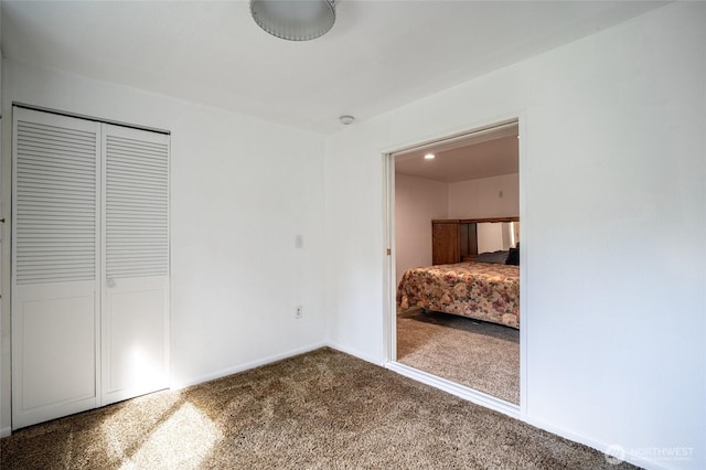 3515 W Tapps Dr E, Lake Tapps, WA 98391 - unfurnished bedroom featuring dark colored carpet, baseboards, and a closet