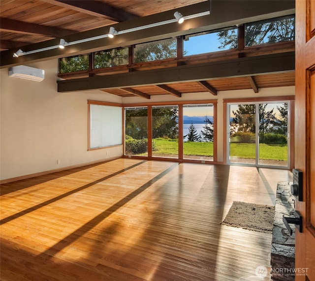 6256 Neupert Rd, Freeland, WA 98249 - interior space featuring an AC wall unit, rail lighting, and beamed ceiling