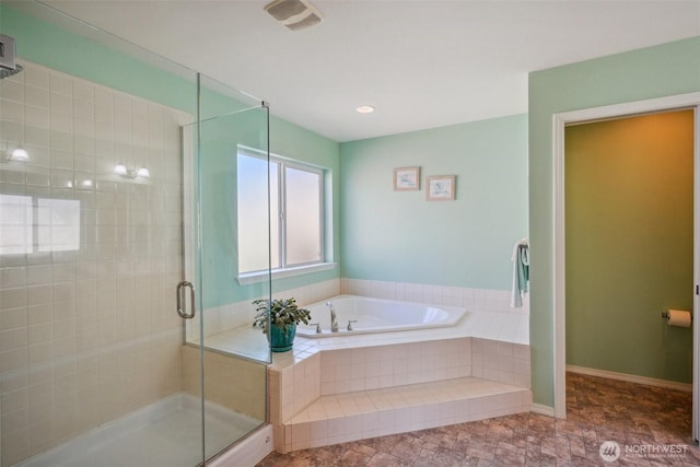 bathroom with a shower stall and a bath