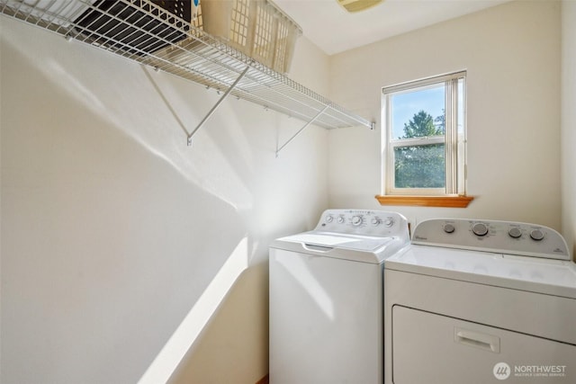 laundry room with washing machine and clothes dryer and laundry area