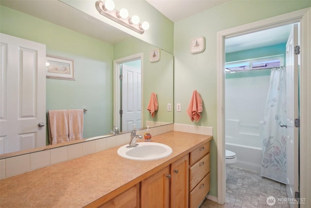 full bathroom with vanity, shower / bath combo with shower curtain, and toilet