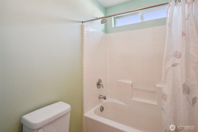 bathroom with shower / bath combo and toilet