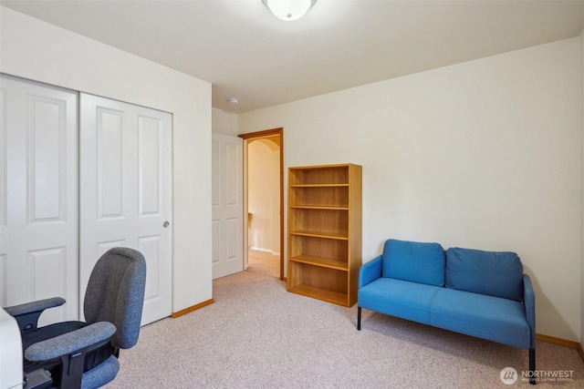 carpeted office featuring baseboards