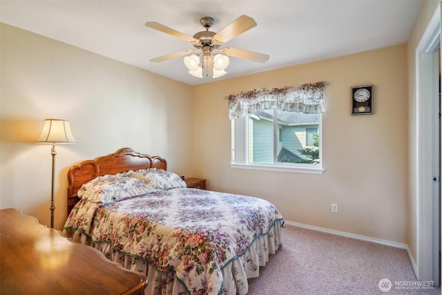 bedroom featuring light colored carpet, a ceiling fan, and baseboards
