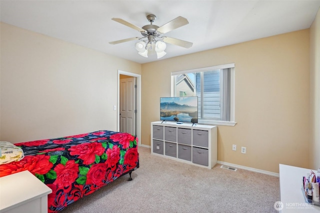 carpeted bedroom featuring baseboards, a ceiling fan, and visible vents