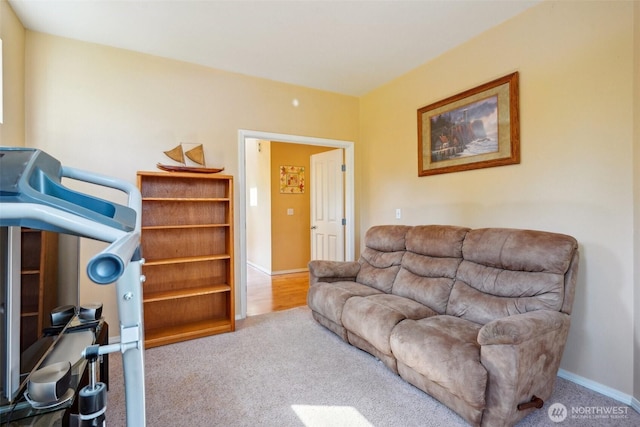 living area featuring carpet floors and baseboards