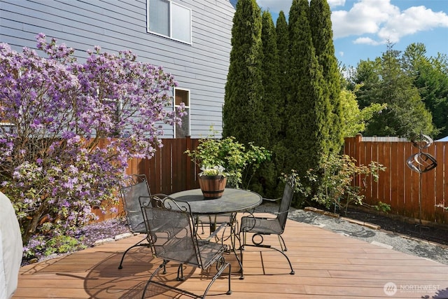 wooden terrace with fence and outdoor dining space