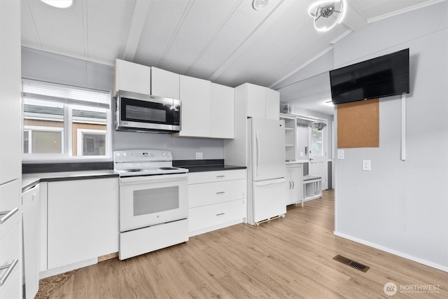 kitchen featuring visible vents, vaulted ceiling, light wood-style floors, white appliances, and white cabinetry