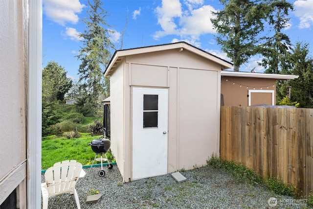 view of shed with fence