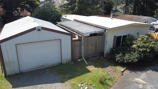 detached garage with fence and driveway