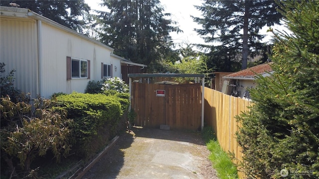 view of property exterior with fence and driveway