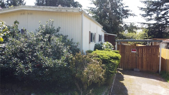 view of side of property featuring fence